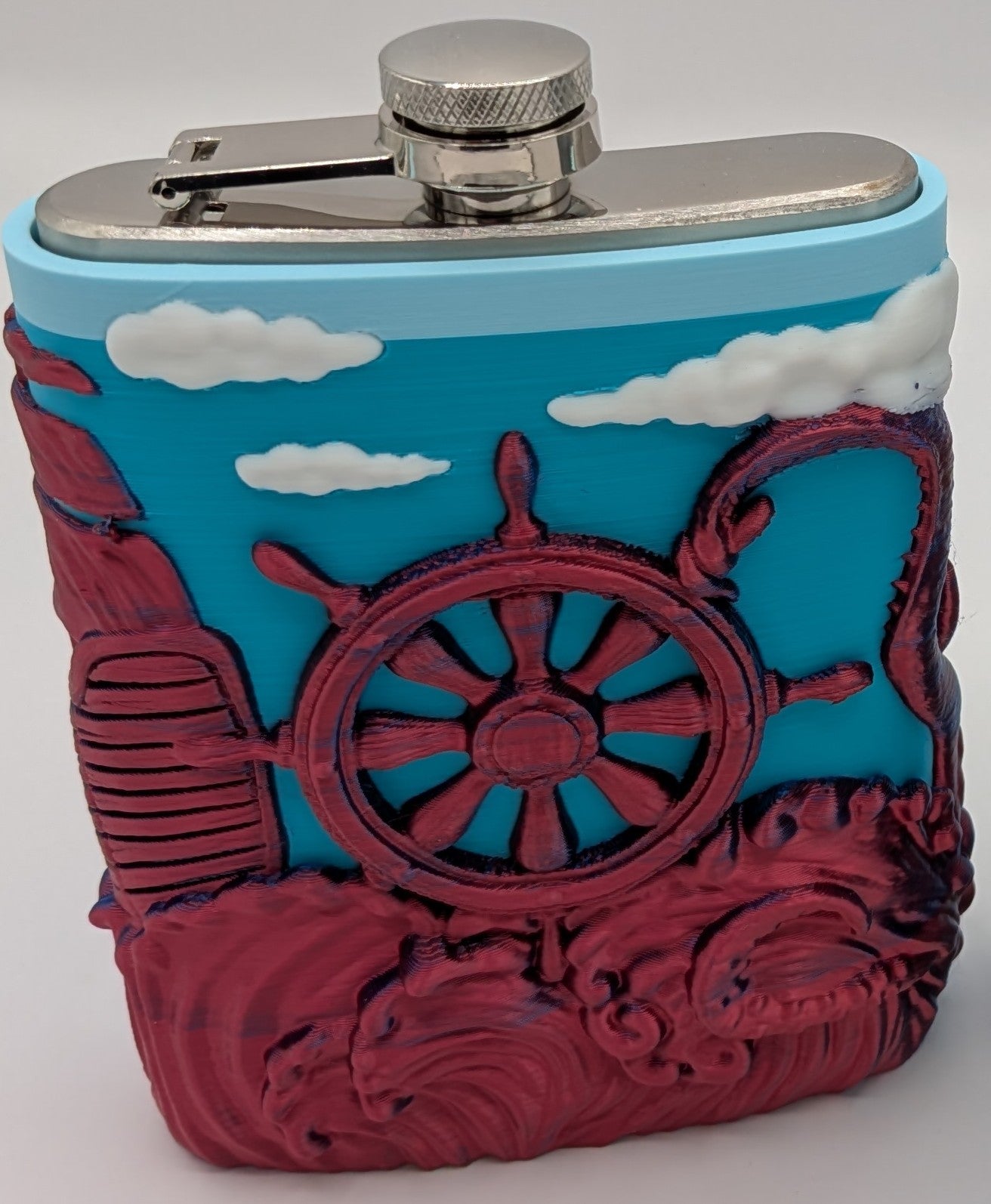 Colorful nautical-themed flask with ship's wheel and sea design, perfect for outdoor adventures or gatherings.