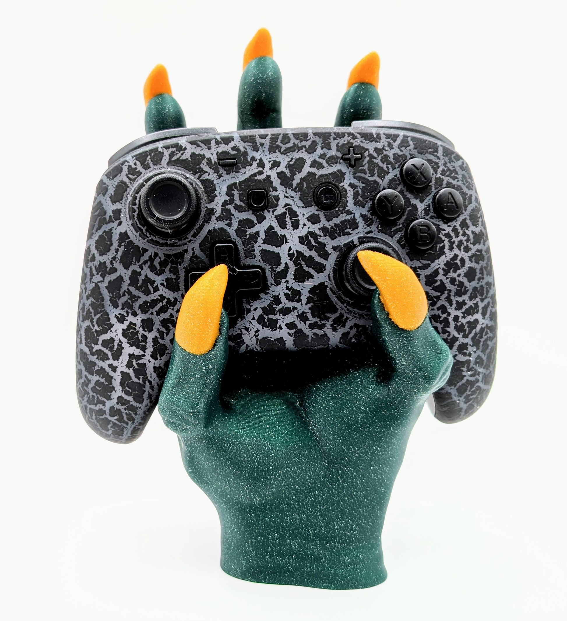 Monster Controller Stand holding a gaming controller with claws, featuring green glitter and orange claws for a spooky design.